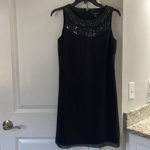 Woman’s sheath black dress with neck sequin detail